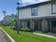 Street view of a townhouse with verdant lawn, mature plantings, and a well-kept neutral-colored exterior at 126 Maitland Ave # 126, Altamonte Springs, FL 32701