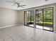 Bright living room with tile flooring and sliding doors that open to a screened-in lanai at 126 Maitland Ave # 126, Altamonte Springs, FL 32701