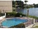 Inviting community pool area with lounge chairs and serene lake view, perfect for relaxation at 126 Maitland Ave # 126, Altamonte Springs, FL 32701