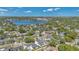 An aerial shot showing homes nestled among lush trees, with a serene lake providing a scenic backdrop at 1312 Vassar St, Orlando, FL 32804