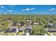 A high-angle aerial view of a suburban neighborhood with many large trees and a distant skyline at 1312 Vassar St, Orlando, FL 32804