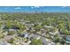 An aerial view capturing a residential neighborhood with tree-lined streets and a distant city skyline backdrop at 1312 Vassar St, Orlando, FL 32804