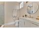 Modern bathroom with a marble countertop vanity, round mirror, and glass-enclosed shower at 1312 Vassar St, Orlando, FL 32804