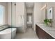 Bathroom view showcasing dual vanities, soaking tub and doorway leading to bedroom at 1312 Vassar St, Orlando, FL 32804