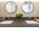A detailed view of a bathroom vanity featuring dual sinks, gray countertops, and decorative floral accents at 1312 Vassar St, Orlando, FL 32804