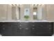 Dual vanities showcasing sleek dark wood cabinets, white countertops, modern fixtures and decorative lighting at 1312 Vassar St, Orlando, FL 32804