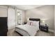 Well-lit bedroom showcases a modern bed, barn door access to the bathroom, and neutral colors at 1312 Vassar St, Orlando, FL 32804