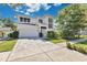 Beautiful two-story modern home with a two-car garage, gorgeous landscaping, and a long walkway to the front door at 1312 Vassar St, Orlando, FL 32804