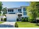 Stunning two-story modern home with a two-car garage, beautiful landscaping, and a walkway to the front door at 1312 Vassar St, Orlando, FL 32804