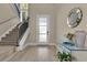 Elegant foyer with hardwood floors, staircase, a decorative mirror and entry to the home at 1312 Vassar St, Orlando, FL 32804