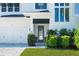 Close up of stylish front door with dark trim and manicured landscaping by the garage at 1312 Vassar St, Orlando, FL 32804