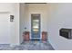 Stylish front door with glass panels, set within a modern entryway featuring potted plants and a mailbox at 1312 Vassar St, Orlando, FL 32804