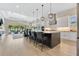 Open concept living with island seating, modern kitchen appliances, and sliding doors to the pool area at 1312 Vassar St, Orlando, FL 32804