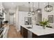 Modern kitchen featuring a large island with seating, stainless steel appliances, and light wood floors at 1312 Vassar St, Orlando, FL 32804
