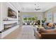 Inviting living room with a modern fireplace, large screen TV, and access to the outdoor pool area at 1312 Vassar St, Orlando, FL 32804