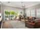 Bright living room with a view of the outdoor pool area through large sliding glass doors, perfect for entertaining at 1312 Vassar St, Orlando, FL 32804