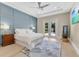 Bright main bedroom with a stylish accent wall, access to the pool, and modern ceiling fan at 1312 Vassar St, Orlando, FL 32804