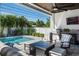 Inviting covered patio with comfortable seating and a view of the backyard pool and outdoor kitchen at 1312 Vassar St, Orlando, FL 32804