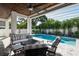 Cozy covered patio with comfortable seating, a ceiling fan, and a view of the backyard pool at 1312 Vassar St, Orlando, FL 32804