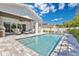 Inviting backyard pool and covered patio with comfortable lounge furniture, perfect for outdoor entertaining at 1312 Vassar St, Orlando, FL 32804