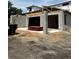 Side view of a two-story home under construction, featuring concrete block and lumber with a dumpster at 1402 Stetson St, Orlando, FL 32804
