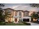 Stunning two-story home featuring a modern design with a brick and stucco exterior, manicured lawn, and professional landscaping at 1402 Stetson St, Orlando, FL 32804