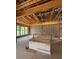 Unfinished living room area showing an exposed ceiling, and large window overlooking greenery and outdoor space at 1402 Stetson St, Orlando, FL 32804