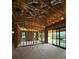 Unfinished living room featuring exposed wood framing, concrete flooring, and a sliding glass door to the backyard at 1402 Stetson St, Orlando, FL 32804