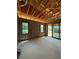Unfinished living room showcasing concrete flooring, two windows, and a sliding glass door that leads to the outside at 1402 Stetson St, Orlando, FL 32804