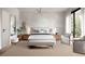 Serene main bedroom with neutral tones, a plush bed, stylish furnishings, and bright natural light from an exterior window at 1402 Stetson St, Orlando, FL 32804