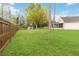 Lush backyard with a storage shed, mature trees, and wooden fence, offering a serene and private outdoor space at 14026 Eckard Ct, Orlando, FL 32826