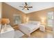 Bright bedroom with vaulted ceilings, ceiling fan, and light wood floors provides a cozy and modern space at 14026 Eckard Ct, Orlando, FL 32826