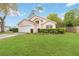 Inviting single-story house with a manicured lawn and a two-car garage at 14026 Eckard Ct, Orlando, FL 32826