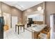 Bright kitchen with white cabinets, a kitchen island with breakfast bar and updated appliances at 14026 Eckard Ct, Orlando, FL 32826