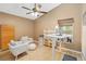 Bright home office with vaulted ceiling, wood floors, white shelving and comfortable seating at 14026 Eckard Ct, Orlando, FL 32826