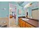 Light-blue bathroom with vanity and shower, visible from the bedroom at 141 Greenfield Rd, Winter Haven, FL 33884