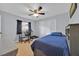 Bedroom with blue comforter, desk, carpeted floor, and closet at 141 Greenfield Rd, Winter Haven, FL 33884