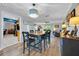 Bright dining room with hardwood floors, backyard view, and open concept layout to living room and kitchen at 141 Greenfield Rd, Winter Haven, FL 33884