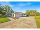 Single-story home with two-car garage, a basketball court, and a well-maintained landscape at 141 Greenfield Rd, Winter Haven, FL 33884