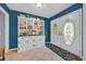 Inviting foyer with stylish tile flooring, white decorative cabinet, and white double doors at 141 Greenfield Rd, Winter Haven, FL 33884