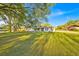 Well-maintained single-story home featuring a spacious front yard, mature trees and an inviting landscape at 141 Greenfield Rd, Winter Haven, FL 33884