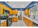 Kitchen featuring stainless steel appliances and light wood cabinets, with tile flooring at 141 Greenfield Rd, Winter Haven, FL 33884