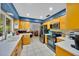 Bright kitchen features updated appliances, light wood cabinets, and tile flooring at 141 Greenfield Rd, Winter Haven, FL 33884