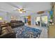 Spacious living room features comfortable leather furniture and a sliding glass door at 141 Greenfield Rd, Winter Haven, FL 33884