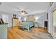 Spacious primary bedroom with hardwood floors, a ceiling fan, and an en-suite bathroom at 141 Greenfield Rd, Winter Haven, FL 33884