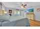 Bright main bedroom with a ceiling fan, light wood flooring, and dresser with decorative touches at 141 Greenfield Rd, Winter Haven, FL 33884