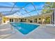 Beautiful backyard pool area with a screened enclosure, patio furniture, and well-maintained pool at 141 Greenfield Rd, Winter Haven, FL 33884