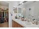 Bright bathroom with dual sinks and walk-in closet at 14467 Prunningwood Pl, Winter Garden, FL 34787