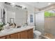 Bathroom features a dual sink vanity and glass-enclosed shower at 14467 Prunningwood Pl, Winter Garden, FL 34787