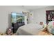 Bedroom with a large TV, closet, and comfortable sleeping area, ready for relaxation at 14467 Prunningwood Pl, Winter Garden, FL 34787